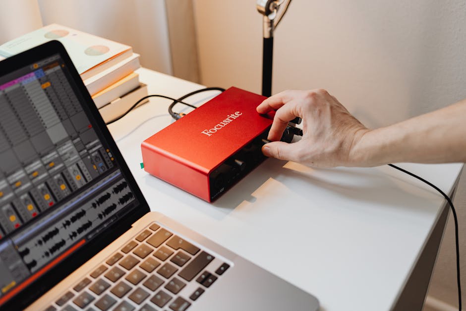 Music professional adjusting studio equipment for optimal performance