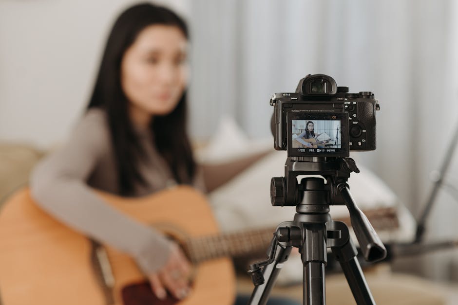 A musician recording a guitar performance for high-definition streaming