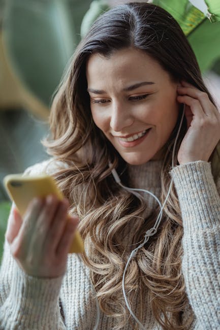Smiling woman experiencing the joy of clear audio with wired earbuds