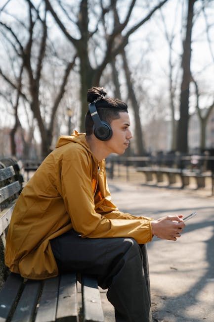 Man listening to outdoor music trends on a park bench